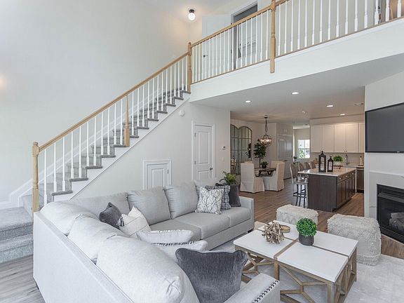 The Port Jefferson - Living room, sofa and staircase photo
