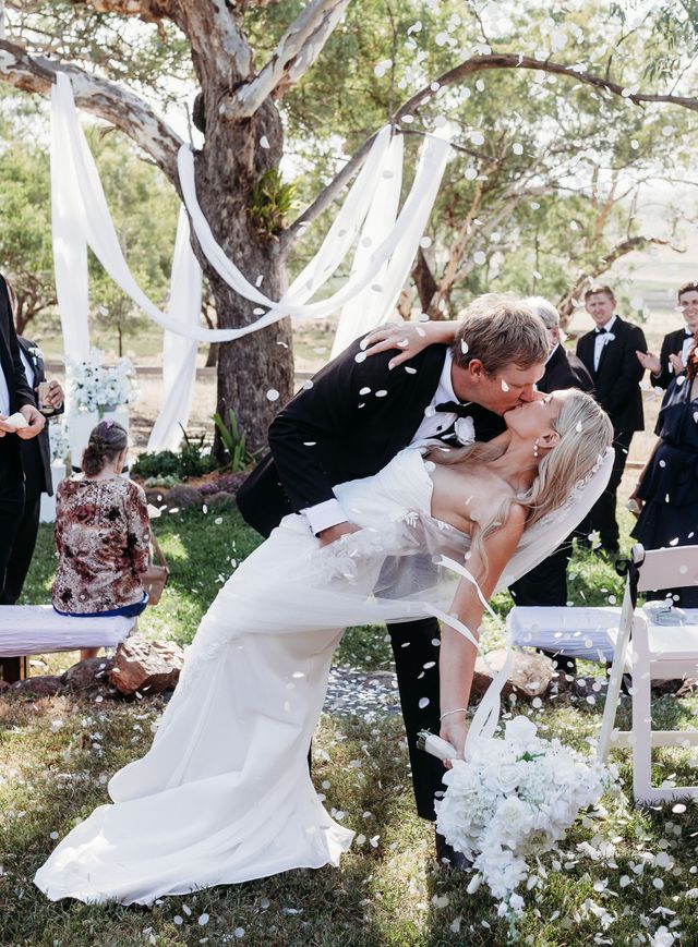 Green pews decorated with baby's breath bouquets, pink ribbons in a church, wedding decor.