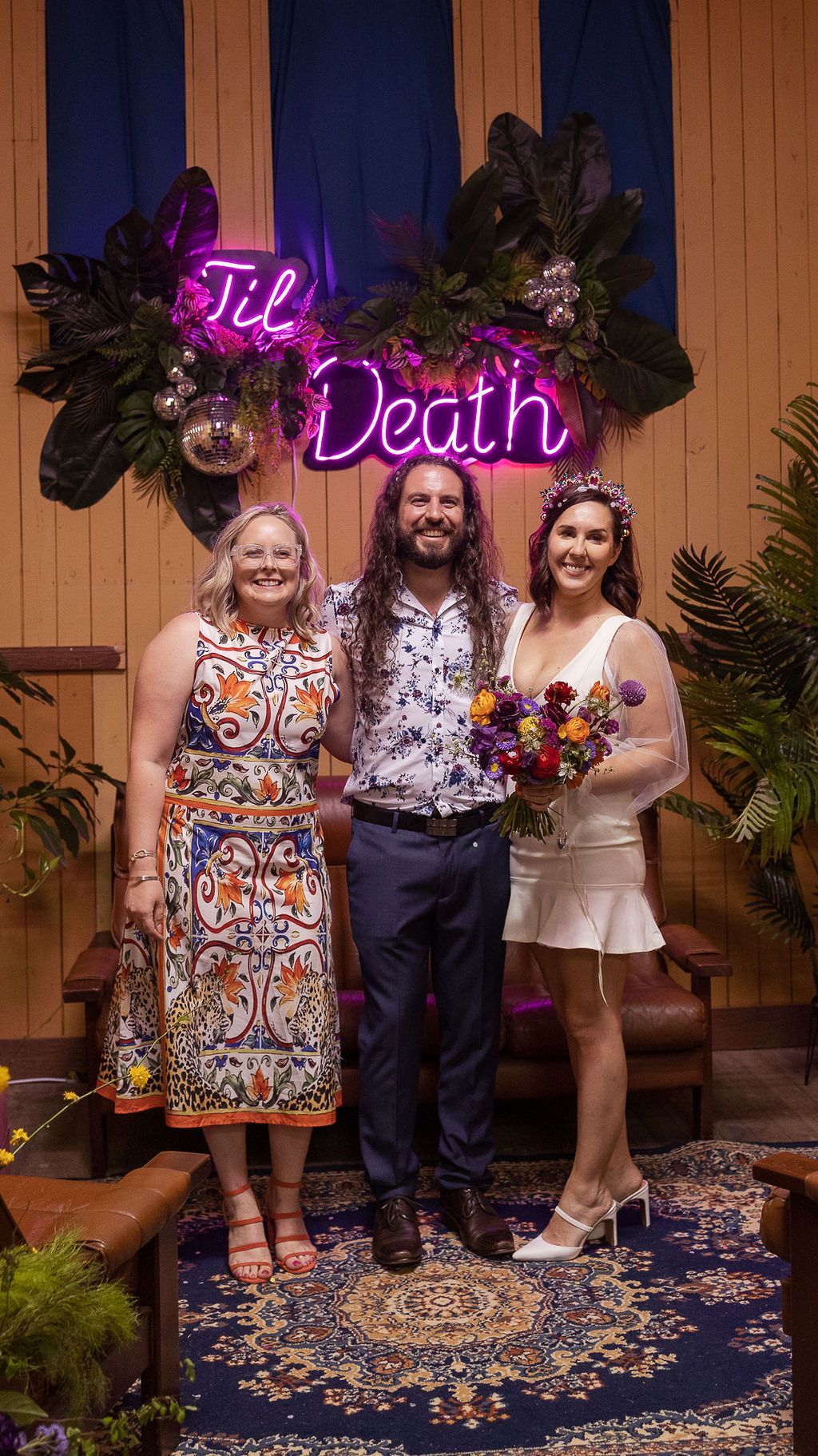 Wedding ceremony: Three people smiling. Neon 