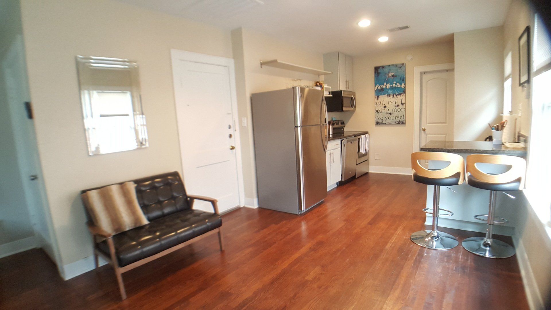 Front door and view of kitchen