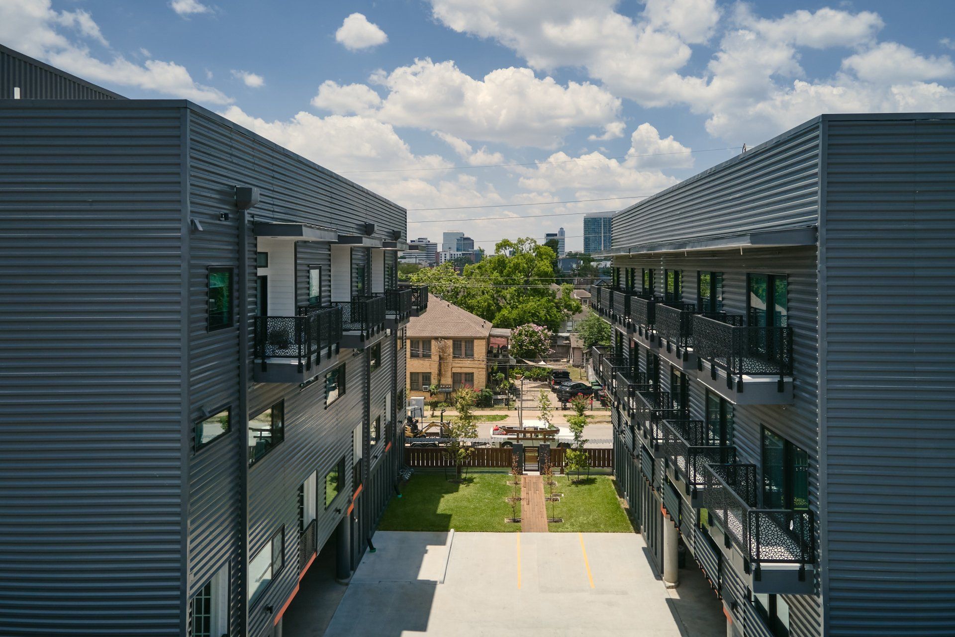 Private balcony at a Houston apartment with tranquil garden and city skyline views.