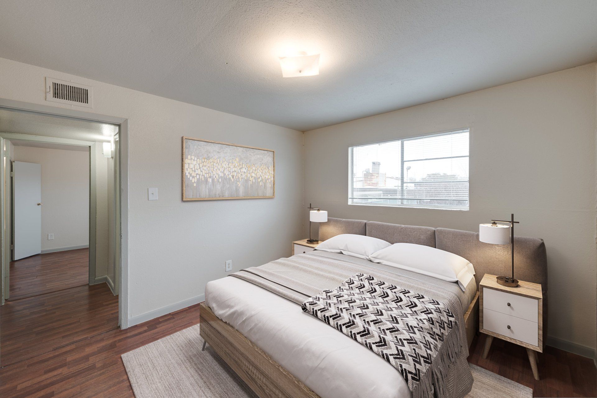 Sunlit master bedroom with serene decor and ample space in apartments for rent in Houston.
