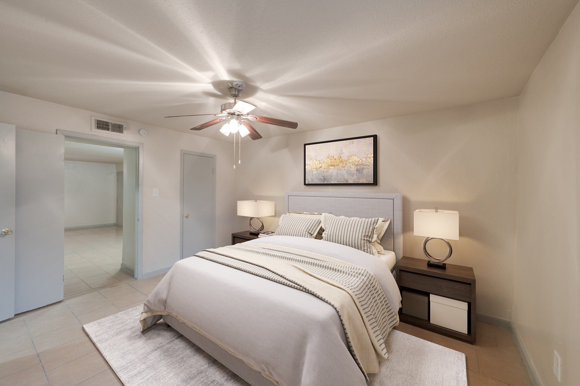 Spacious, well-lit master bedroom in a one-bedroom Houston apartment for rent, with a large bed.