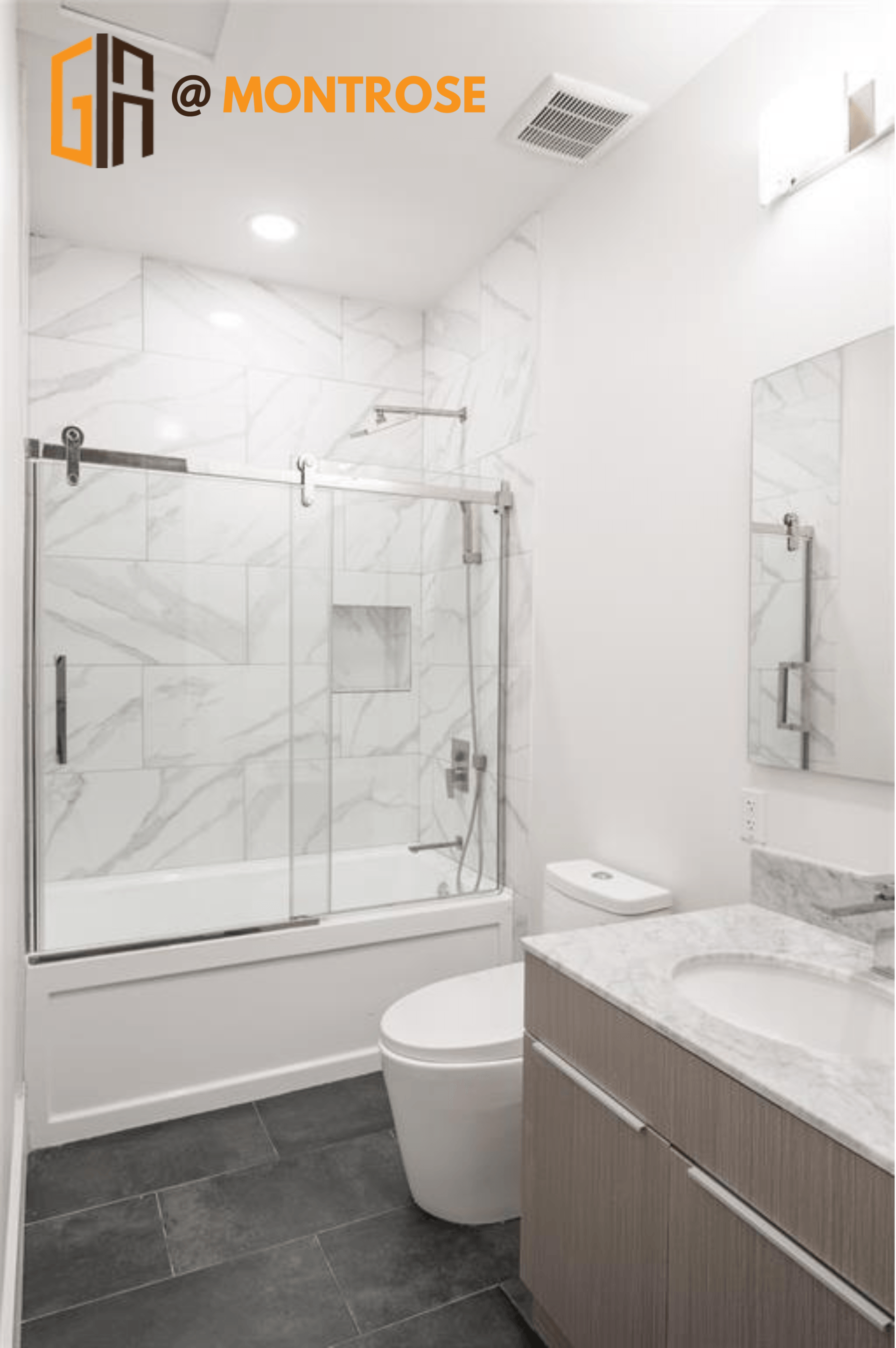 Stylish Montrose Houston apartment bathroom featuring glass shower and contemporary tile flooring.