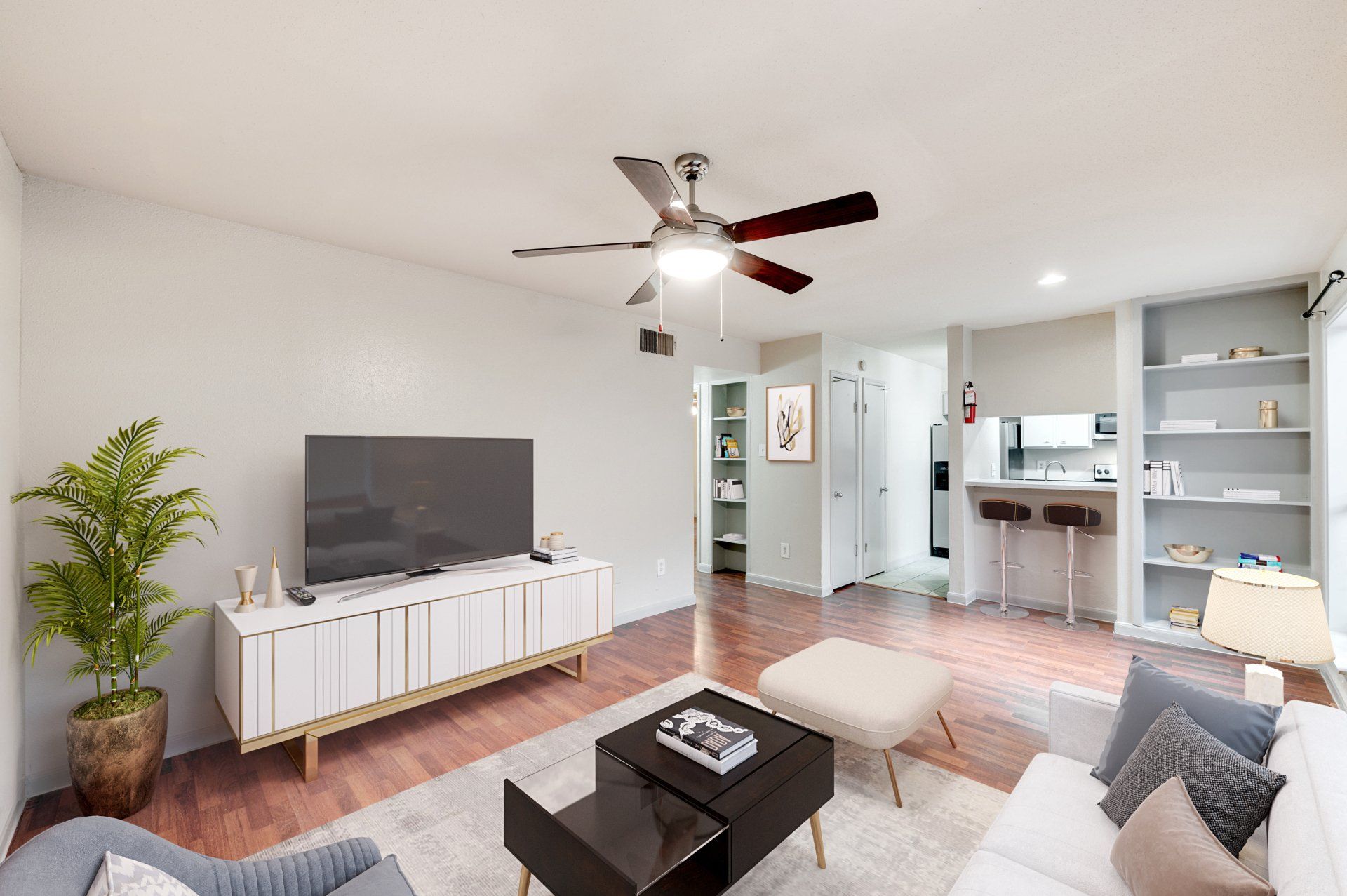 Modern, remodeled living space in a Gia Westchase apartment for rent in Houston, with open-concept kitchen.