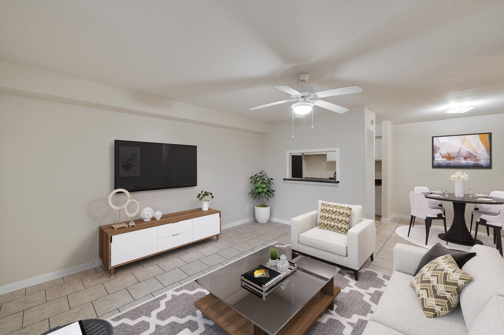 Modern, open-concept living/dining in Houston TX apartment for rent. Fan, armchair, dining table.