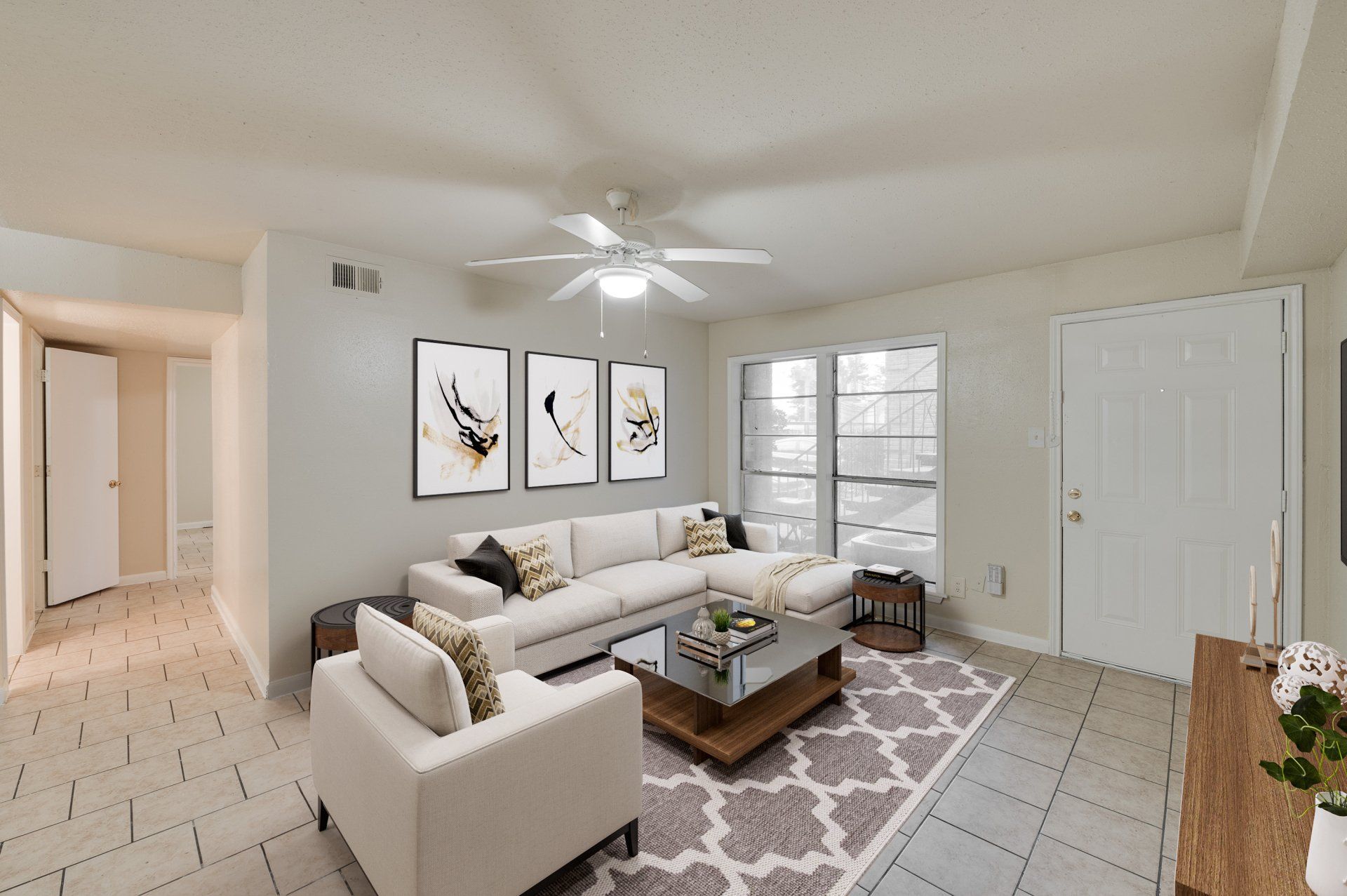 Cozy living room in a Gia IV Bellaire apartment for rent, Houston. Sectional, art, natural light.