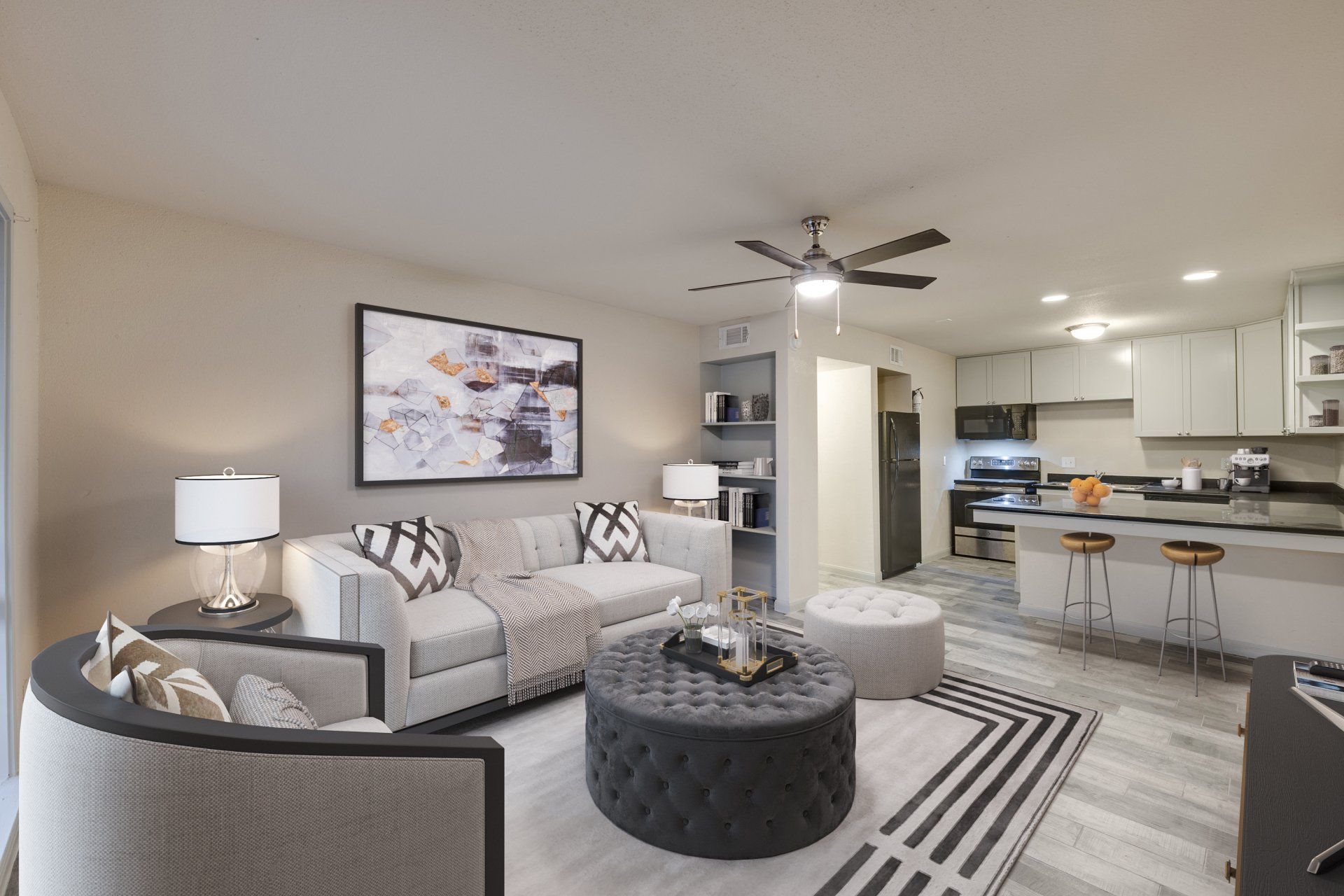 Modern living room and kitchen with luxury plank flooring at  Gia Oak Forest, Houston.
