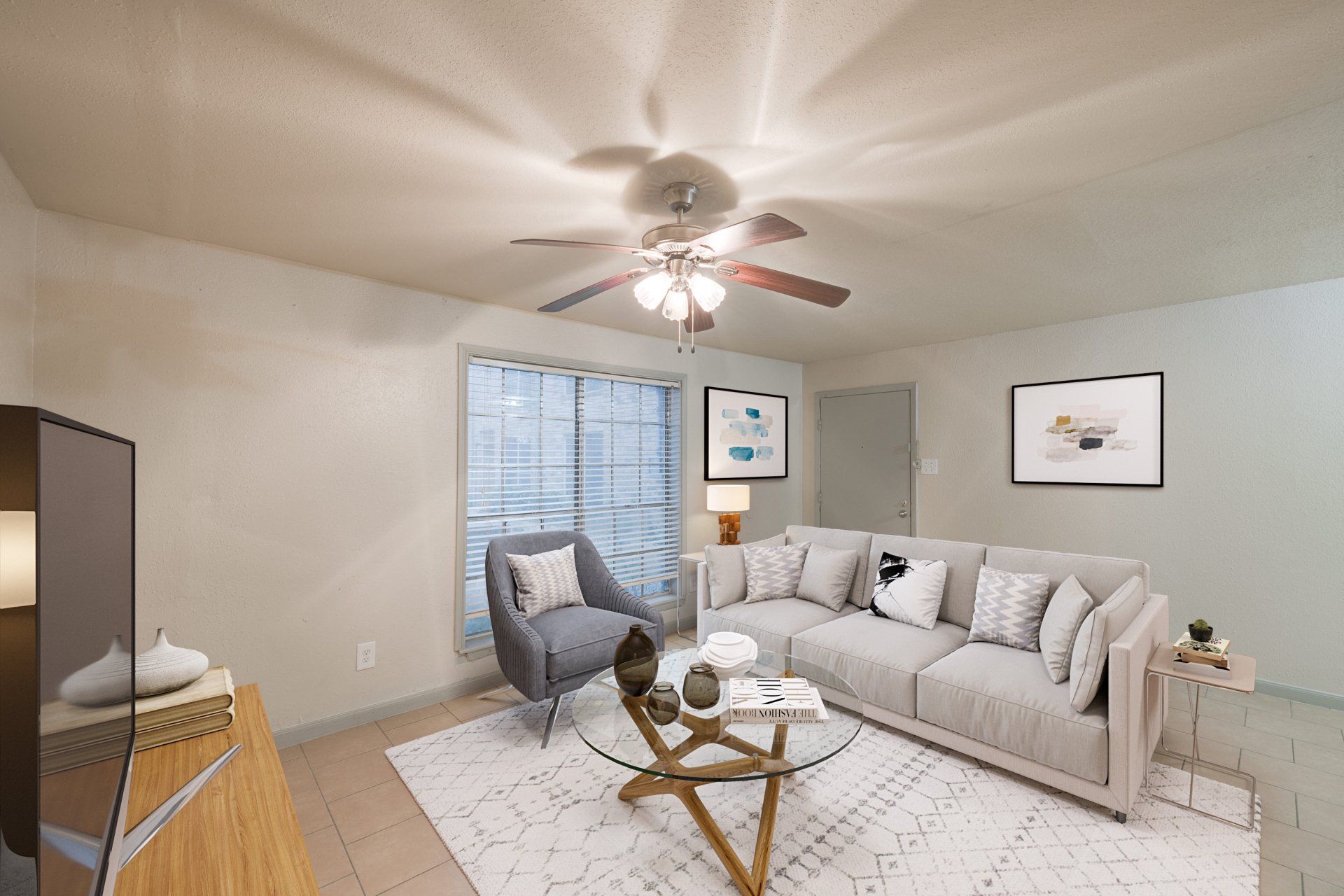 A bright, modern living room in our apartments in Houston, TX, showing ample space for an entertainment unit and seating.