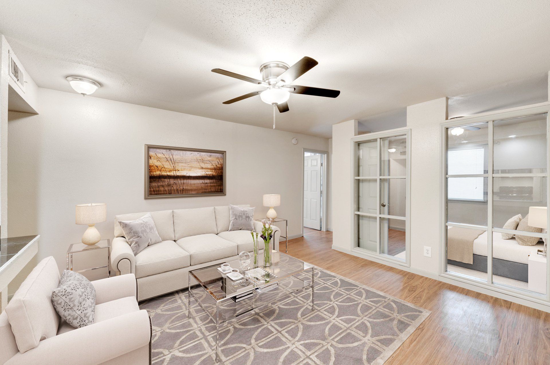 Modern living room at GIA Westchase with ceiling fan, perfect for Westchase District Houston apartments.