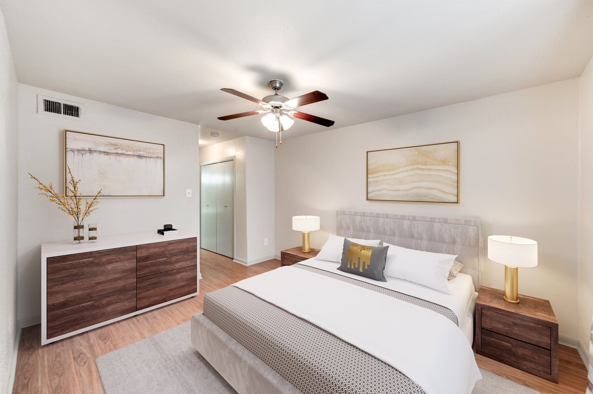 Modern bedroom at GIA Westchase with luxury flooring and ceiling fan, for Houston apartments.