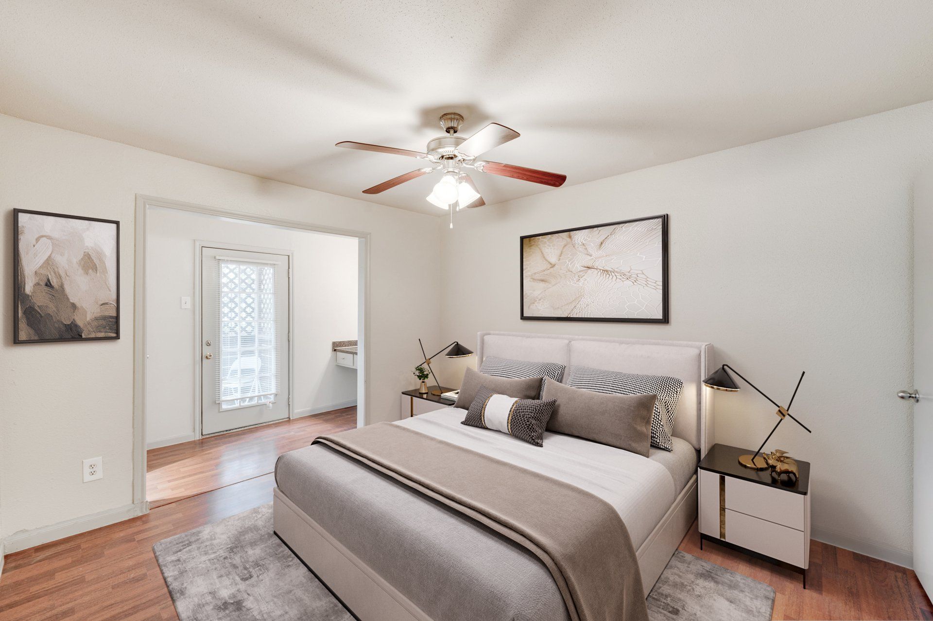 Modern bedroom at Gia Westchase, with ceiling fan and private patio, in Westchase District Houston apartments.