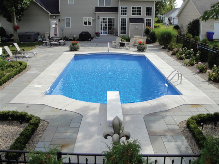 A large swimming pool in the backyard of a house