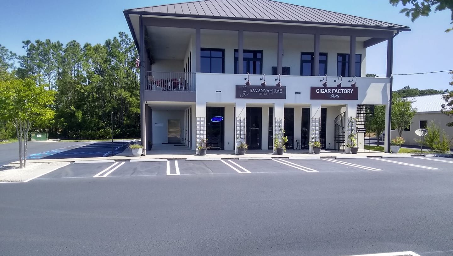Modern two-story building with shops and parking.