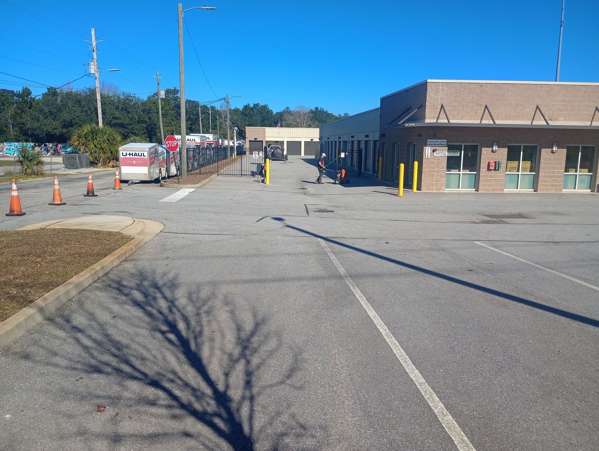 An open concrete parking lot with a building to the right.