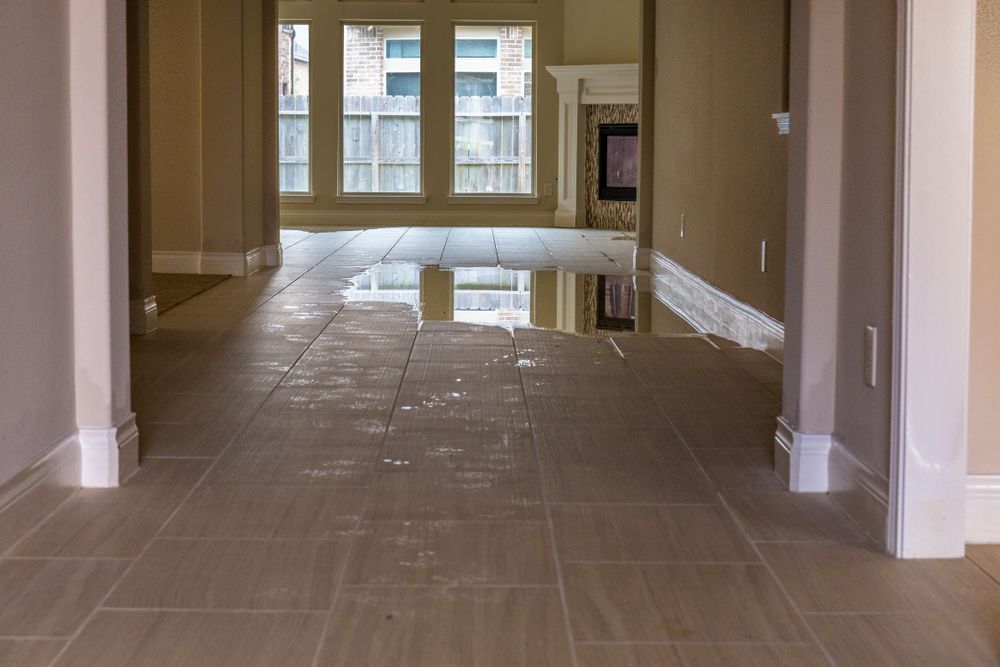 Empty Hallway with Beige Tile Floor and Windows at The Far End — Broadbeach Carpet Cleaning In Broadbeach, QLD