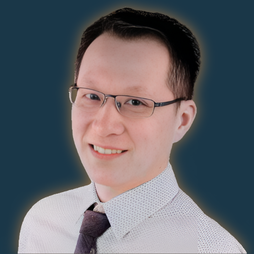 A man wearing glasses and a tie smiles for the camera