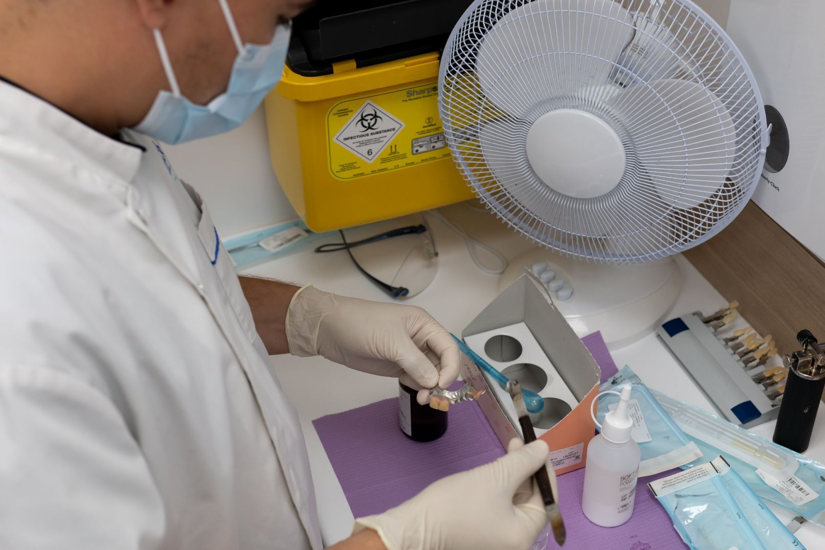 Dentist Preparing Dental Work at a Workstation — Dentures Direct Ballina In Ballina, NSW