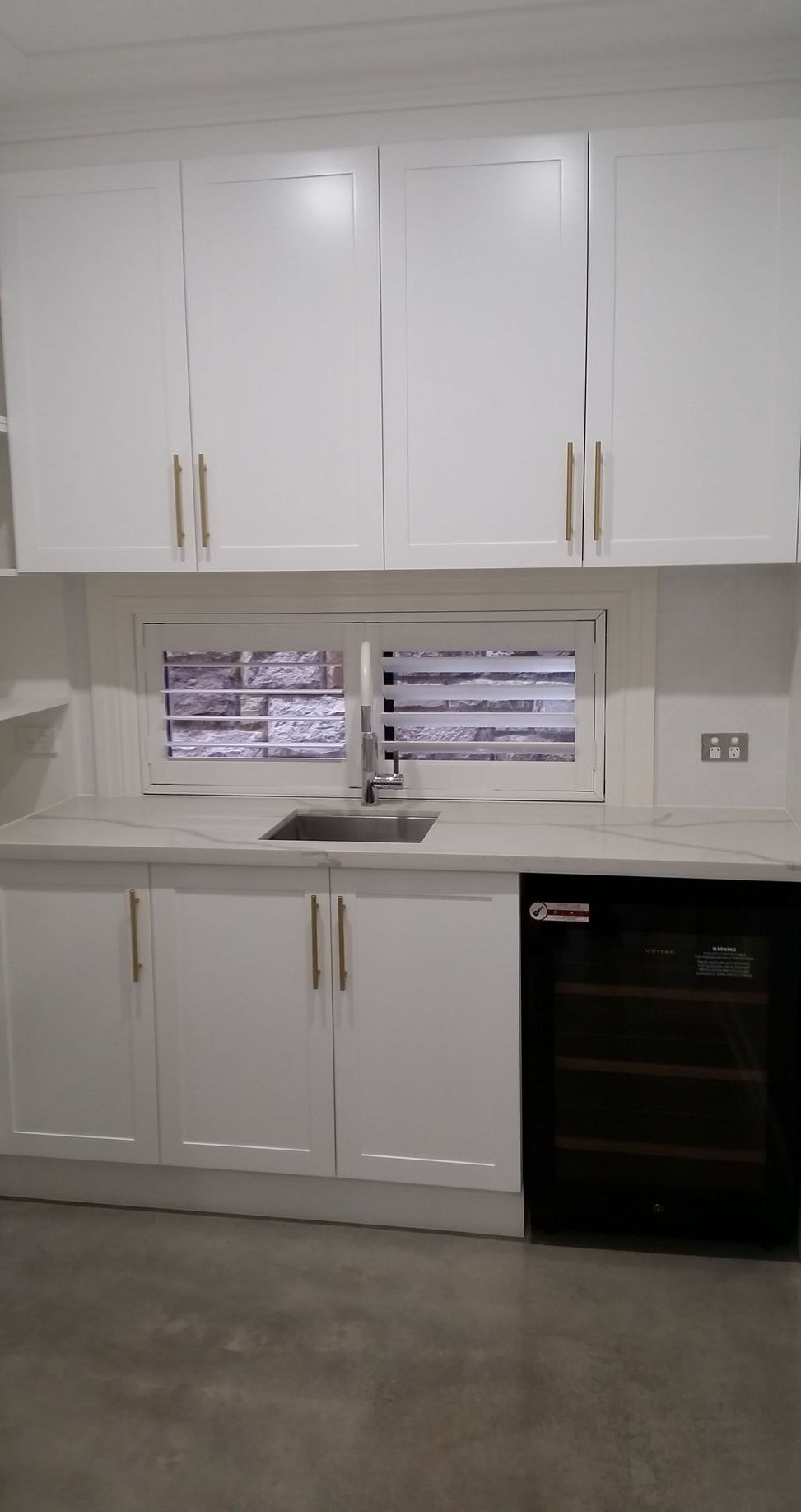 A Man is Installing a Security Camera on the Ceiling — All About Quality Plumbing Services In Halekulani, NSW