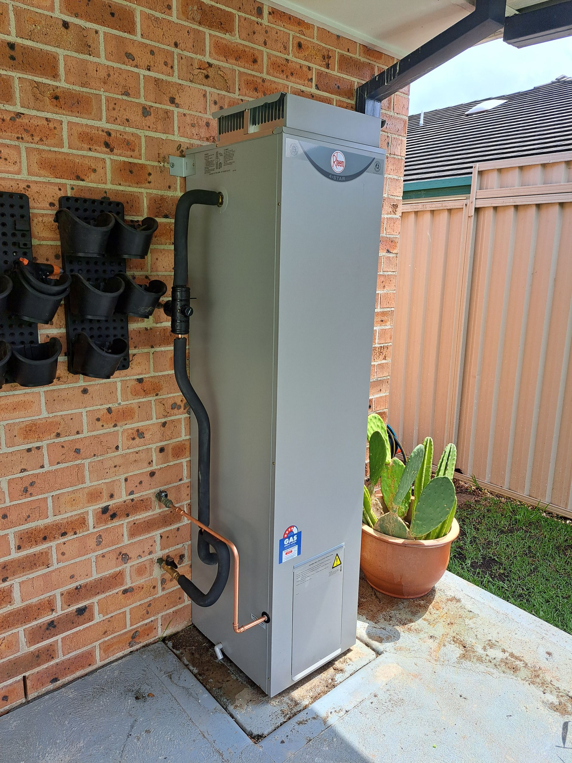 Hot water system installed outside a residence. — All About Quality Plumbing Services In Halekulani, NSW