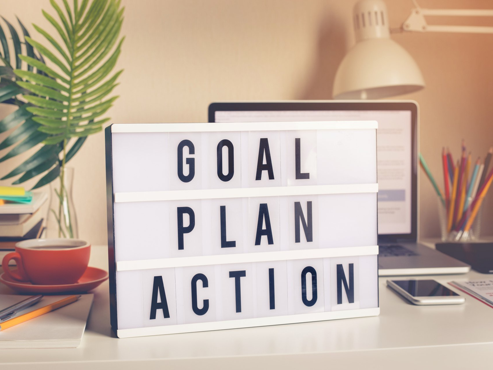 Image showing a board with the words stacked, 'Goal', 'Plan', 'Action'