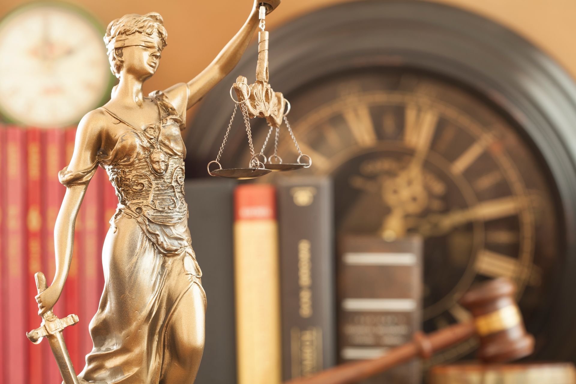 A statue of lady justice holding a gavel and scales of justice