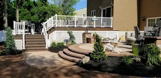 A house with a large deck and stairs leading to it.