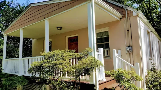 A small house with a porch and stairs