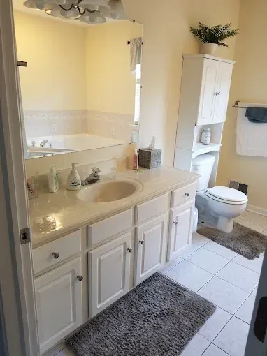 A bathroom with a sink , toilet , and bathtub.