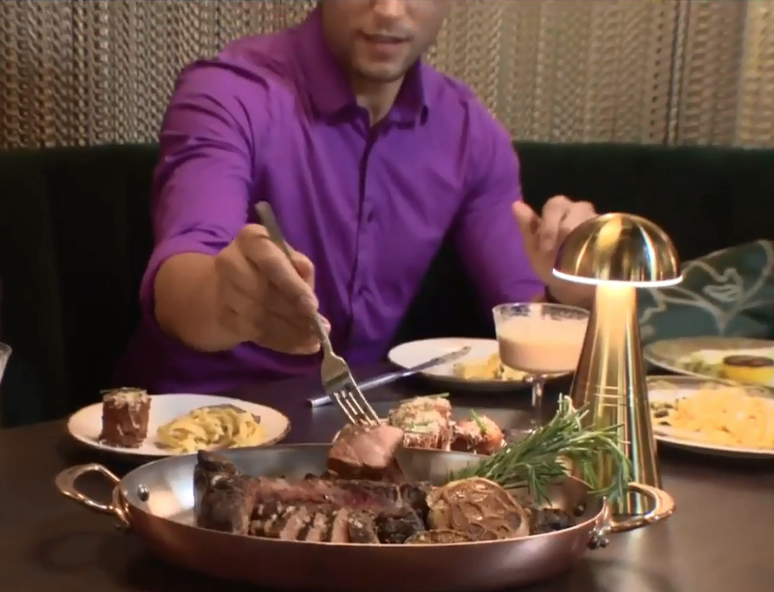 man in purple shirt dining at Timpano Las Olas