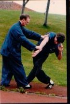 Two men are practicing martial arts in a park. Tai Chi Chuan application. Five Winds Edinburgh
