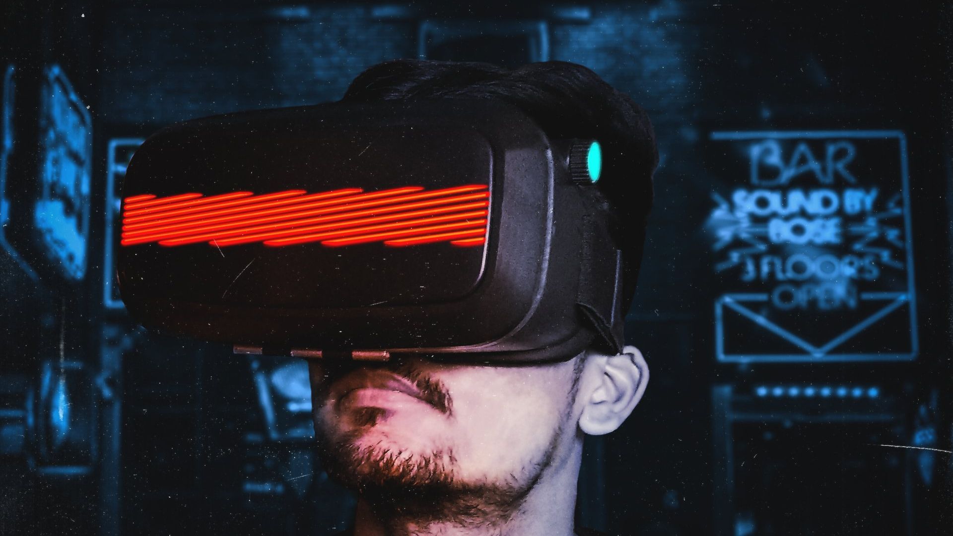 Man with goatee wearing a VR headset with red lines