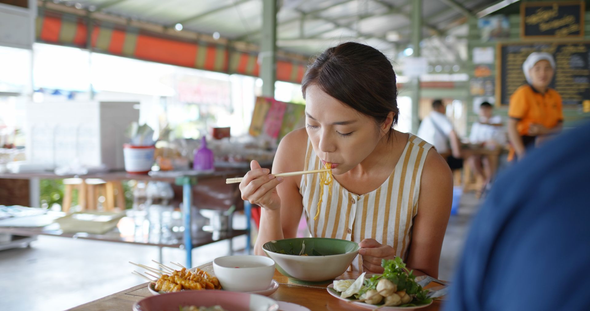 lady eating boat noodles