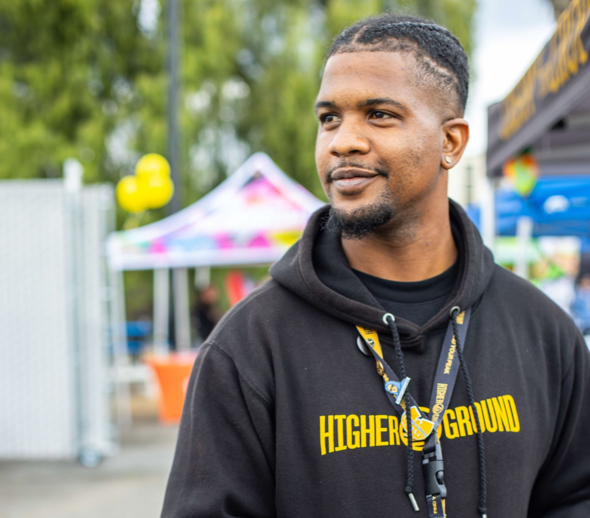 a group of people are posing for a picture in a store called higher ground in San Bernardino