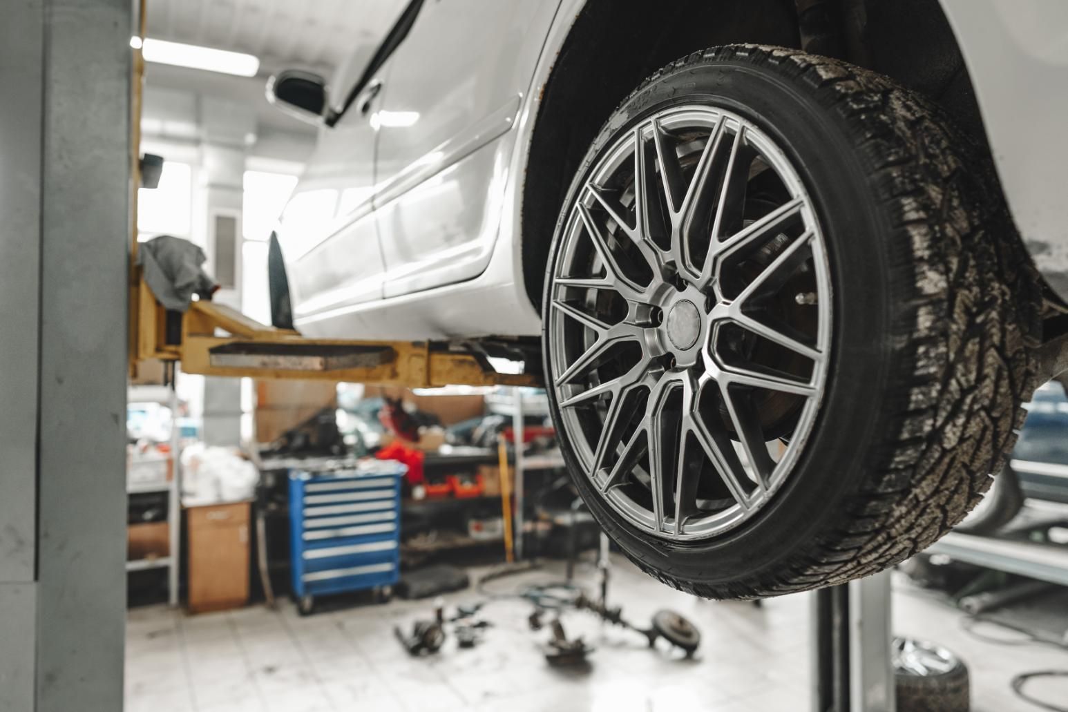 A Car Is Sitting On A Lift In A Garage — Coastwide Automotive Repairs In Nambour, QLD