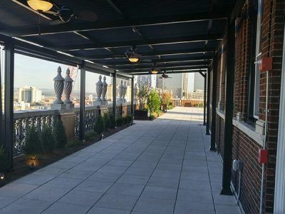A long walkway between two buildings with a view of a city.