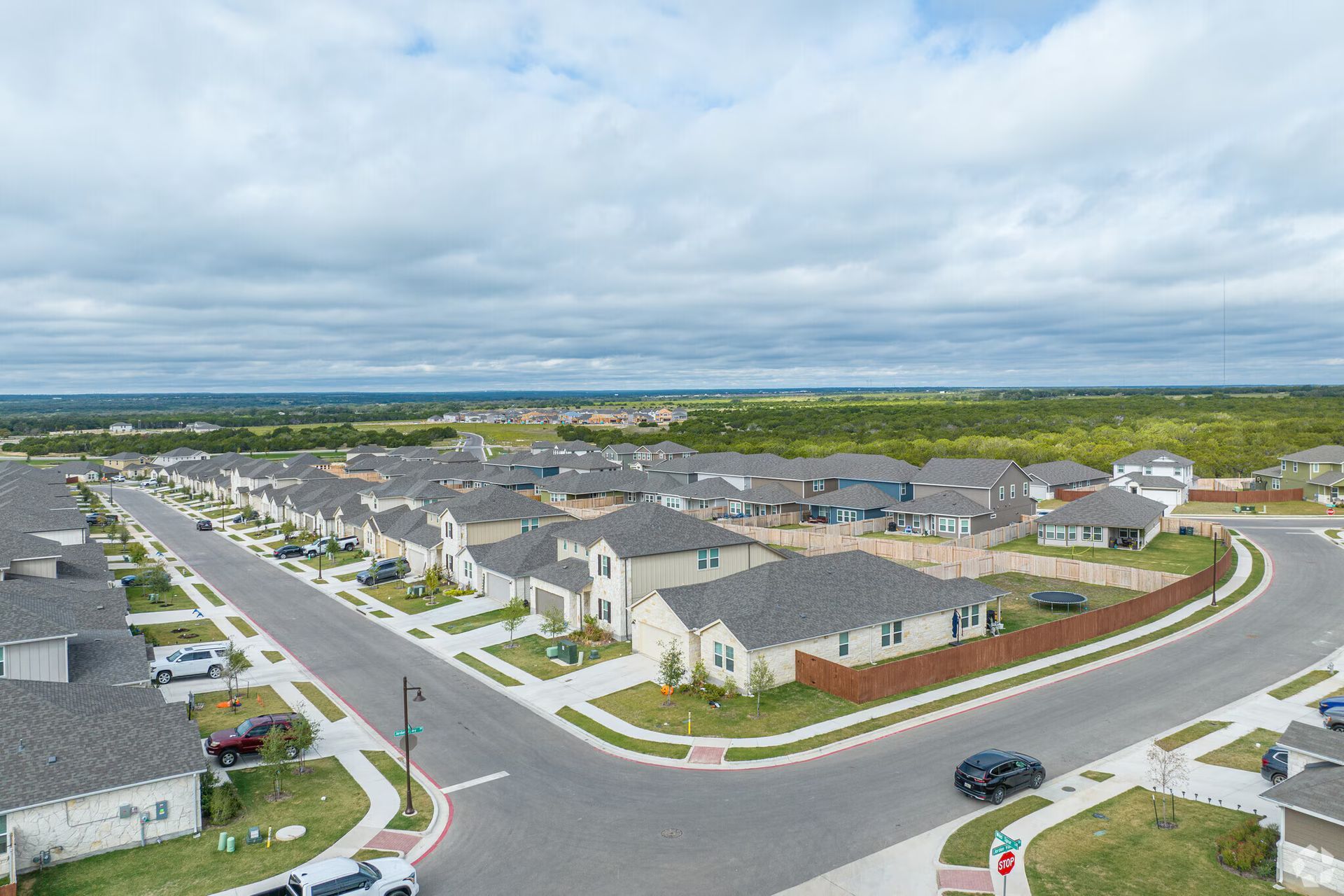 A living room with a couch , chairs , coffee table , fireplace and television.