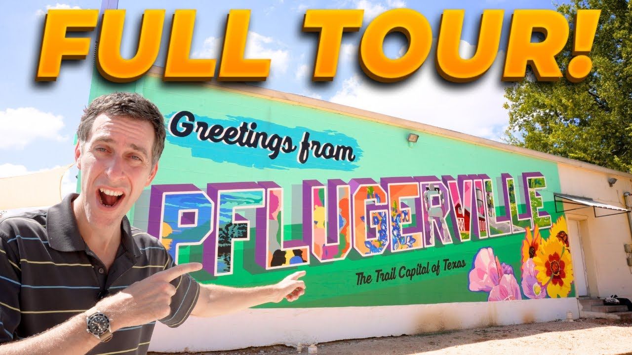 Man points at a colorful mural of 