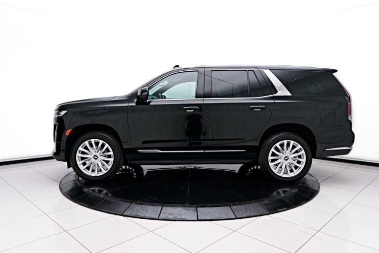 A black suv is parked on a white tiled floor.