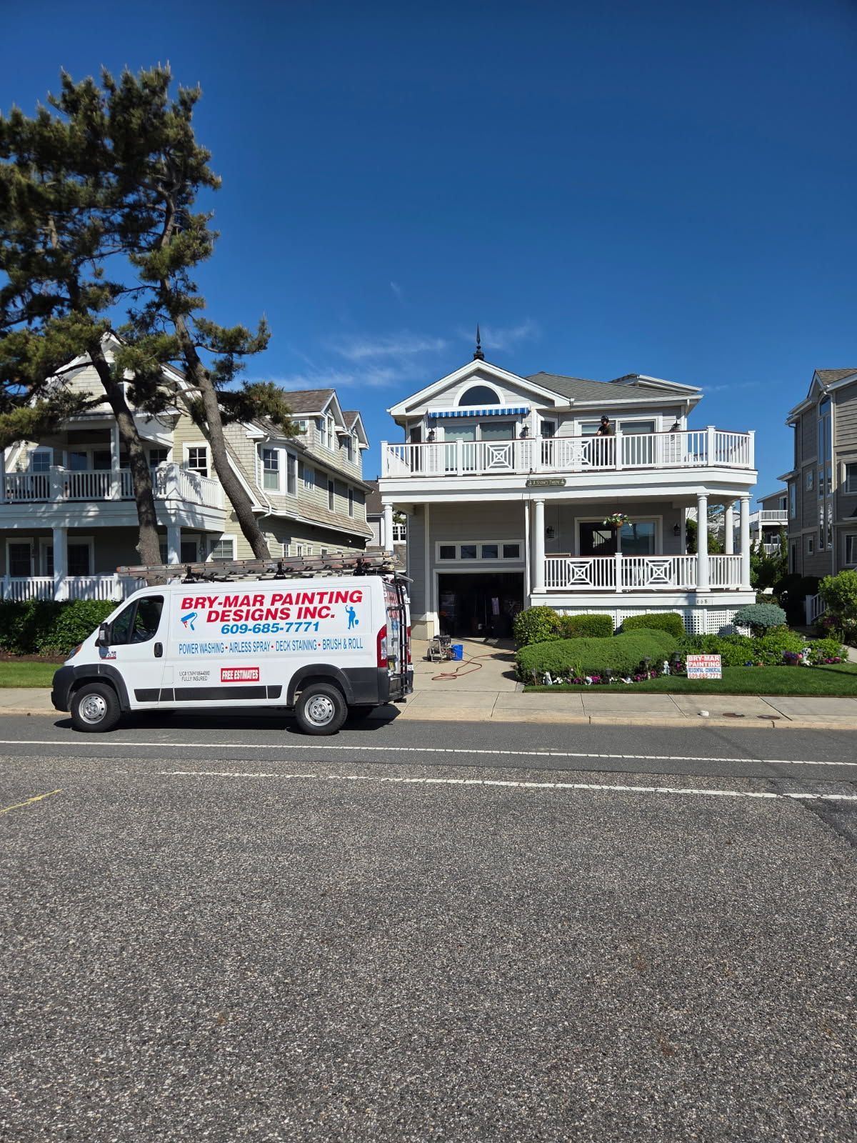 a painted house with a bry-mar painting van in front