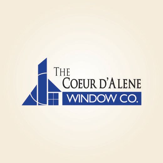 Logo for The Coeur d'Alene Window Co., featuring a blue house-shaped graphic and text on a cream background.
