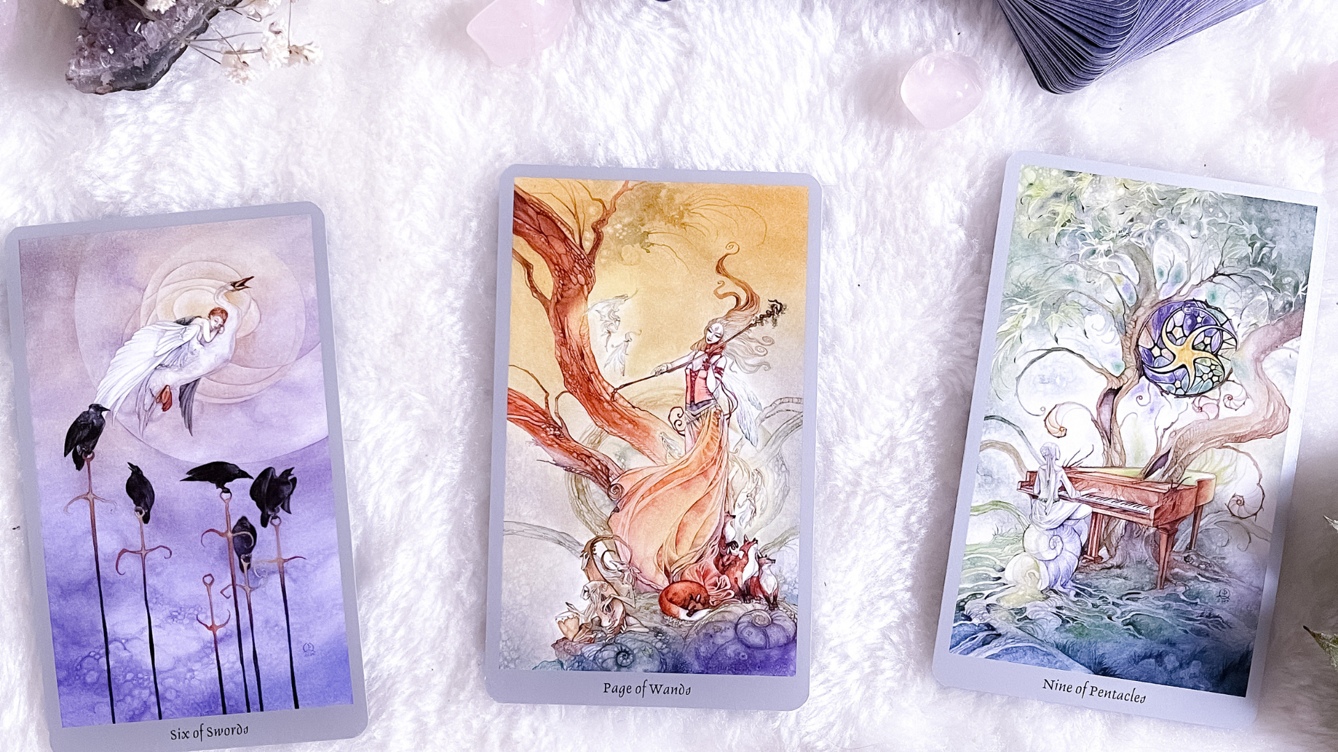 three tarot cards with one that says ' swords ' on it