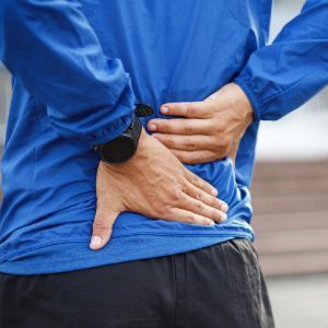 Person Holding Back Suffering From Back Pain