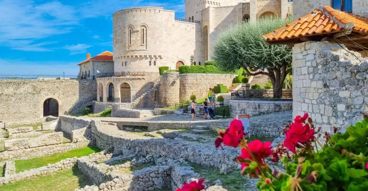 There is a castle in the background with flowers in the foreground.