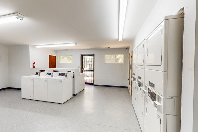 A laundromat with a lot of washers and dryers