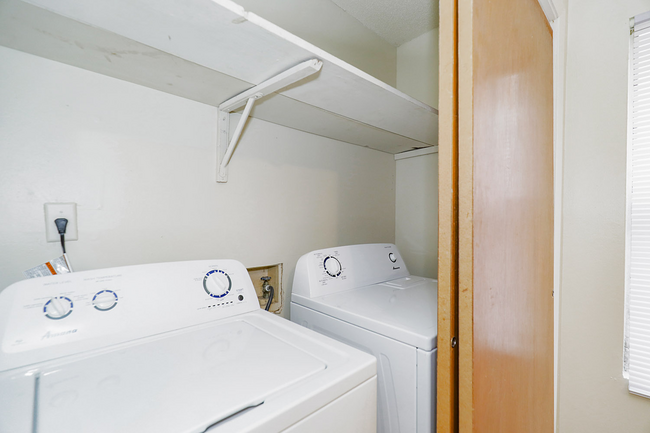 A laundry room with a washer and dryer in it.