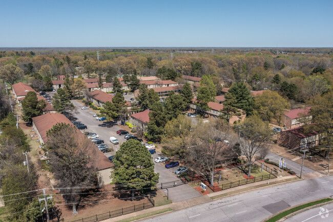 An aerial view of a residential area with lots of trees and buildings.