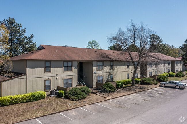A large apartment building with a car parked in front of it.