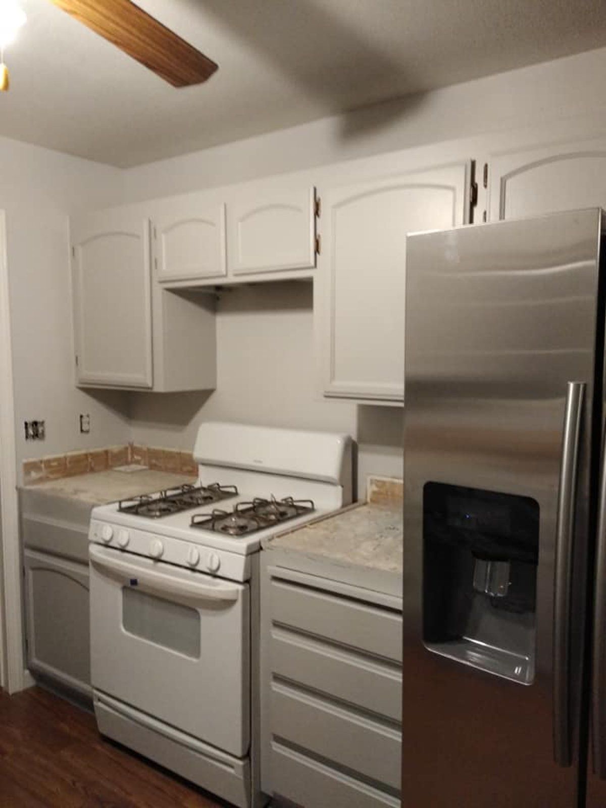 A kitchen with stainless steel appliances and white cabinets