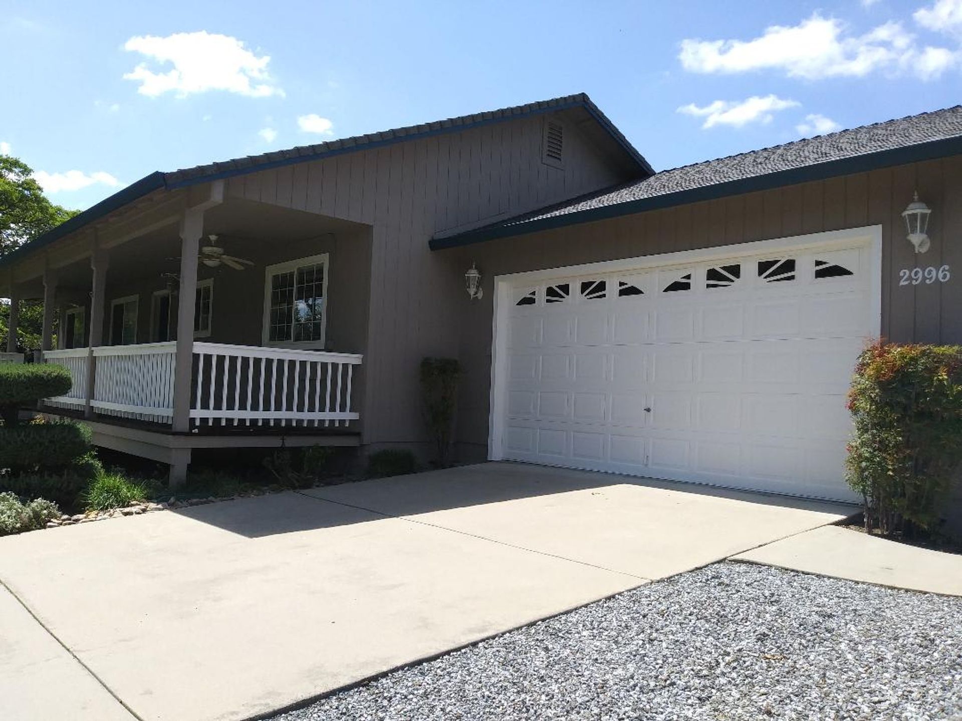 A house with a white garage door and a porch